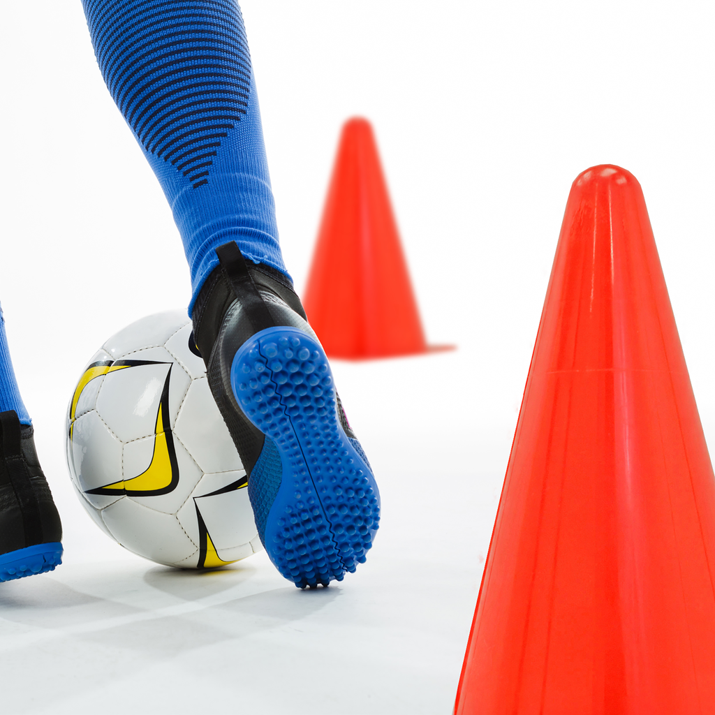 A person using the training cones while practicing soccer