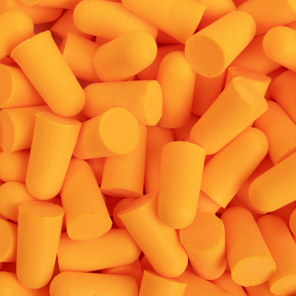 Close up of a bunch of ultra soft foam orange ANSI compliant 32DB-NRR ear plugs