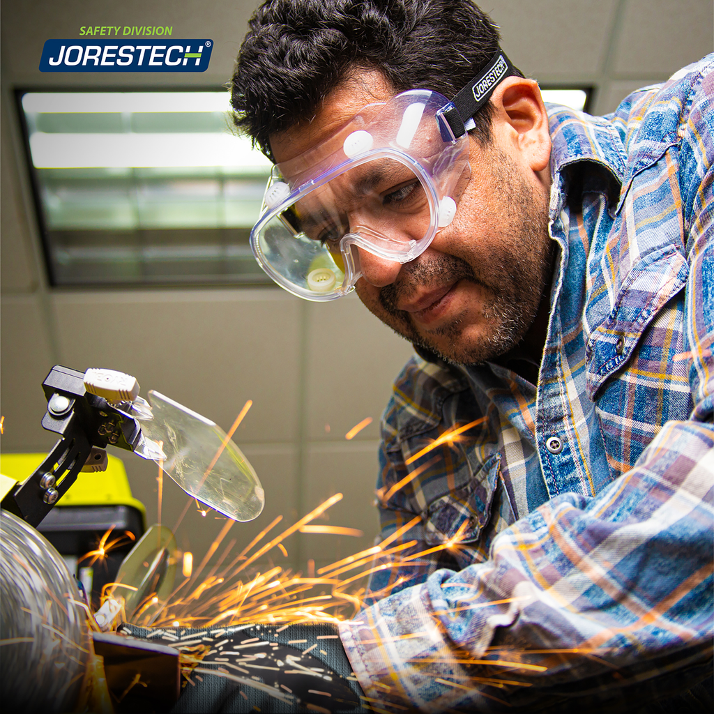 Image show a man wearing JORESTECH safety goggle while operating a power tool machine
