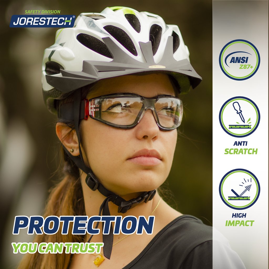 Image shows a young woman using a bicycle white protective helmet and the JORESTECH Red and clear anti fog safety glasses with the adjustable elastic headband.  
