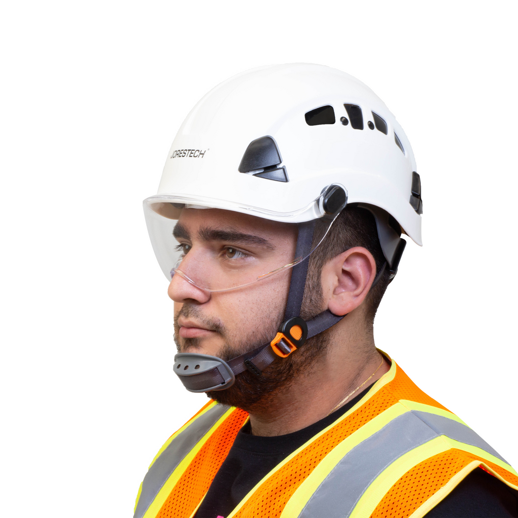 Worker wearing a white hard hat with a chin strap and the JORESTECH eye shield installed. The eye shield is in front of the persons face to protect his eyes from impacts