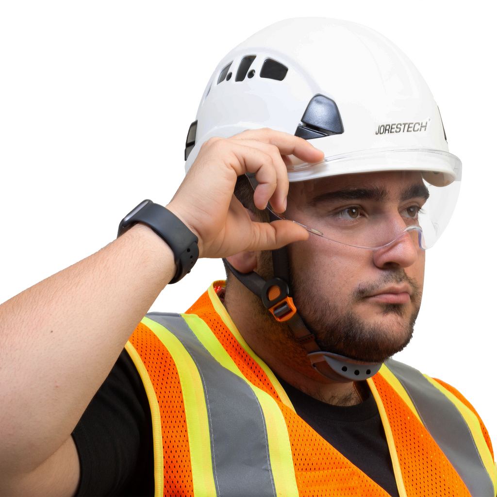 Worker wearing a white hard hat with the JORESTECH eye shield installed. The man is grabbing the eye shield to place it on top of the hard hat or away from his face.