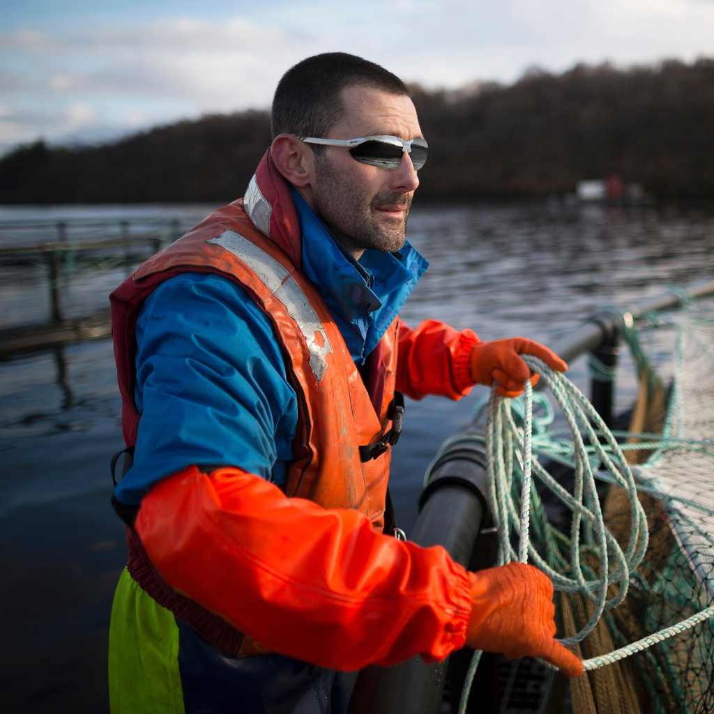 A man using the JORESTECH wrap around safety glasses for sun protection during boating and fishing outdoors